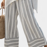 Daisy set z asimetrično bluzo in prugastimi hlačami za moden in eleganten stil